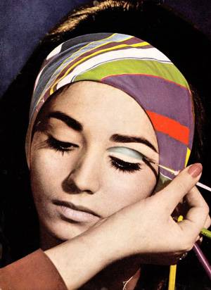 Model applying eyeshadow - 1970s