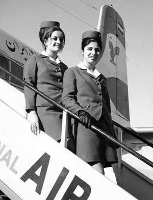 Iran Air flight attendants posing by a DC6 Plane - 1960s
