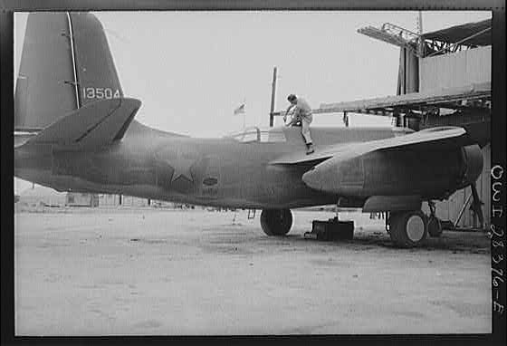 American airplane mechanic putting finishing touches to a warplane before delivery to the Russians. Somewhere in Iran.