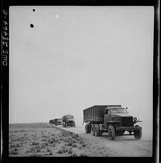 Somewhere in the Persian corridor. A United States Army truck convoy carrying supplies for Russia on a desert road.
