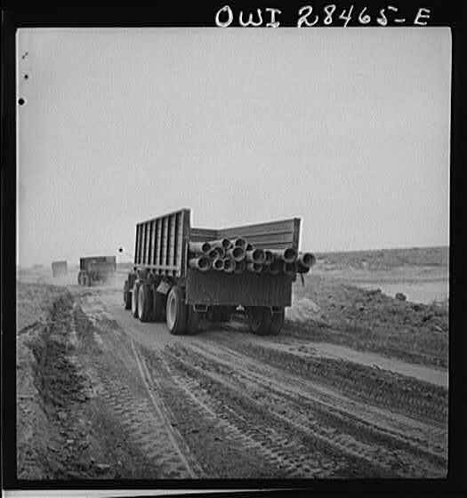 Somewhere in the Persian corridor. A United States Army truck convoy carrying supplies for Russia moving along on a sandy desert road.