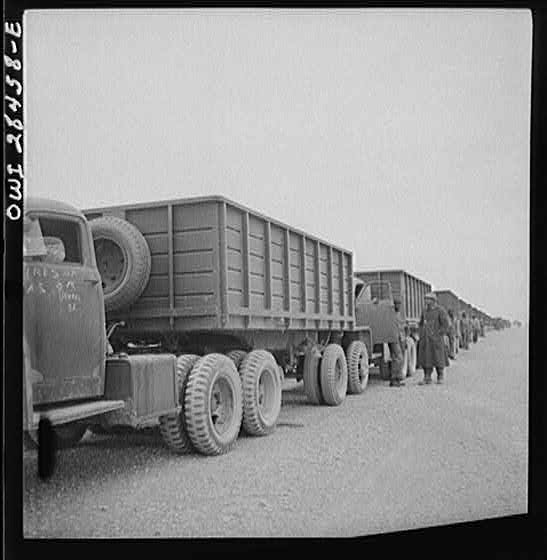 Somewhere in the Persian corridor. A United States Army truck convoy carrying supplies for the aid of Russia stopping for a rest.