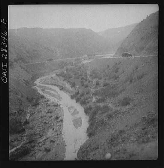 Somewhere in the Persian corridor. A United States Army truck convoy carrying supplies for Russia winding around a gorge in the mountain pass.