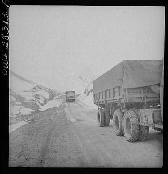 Somewhere on the Persian corridor. A United States Army truck convoy carrying supplies for the aid of Russia on a mountain road.
