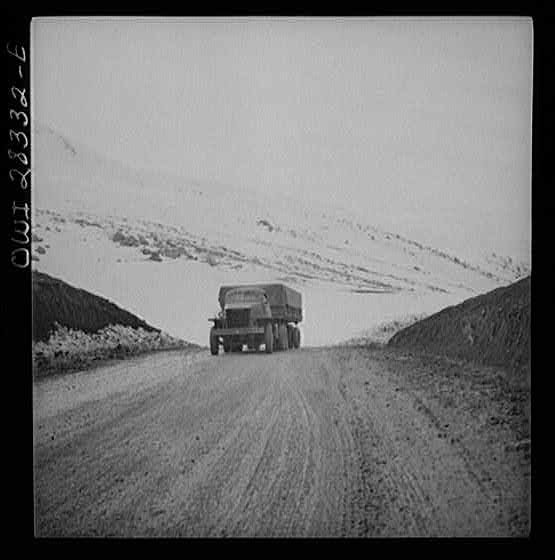 Somewhere in the Persian corridor. A United States Army truck convoy carrying supplies for the aid of Russia climbing a mountain road over the Iranian mountains.