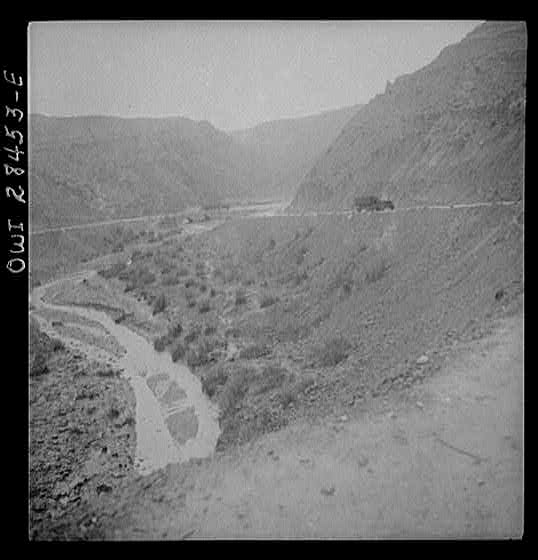 Somewhere in the Persian corridor. A United States Army truck convoy carrying supplies for the aid of Russia winding its way around a gorge over a mountain pass.