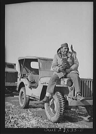 Somewhere in the Persian corridor. A United States Army truck convoy carrying supplies for Russia. OWI (Office of War Information) photographer Nick Parrino on the jeep which he rode in making a photographic record of the first run by an all-American convoy.