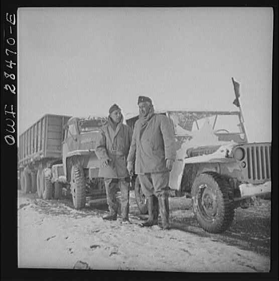 Somewhere in the Persian corridor. A United States Army truck convoy carrying supplies for Russia. Captain J. Priggee, Newark, New Jersey, and Lieutenant. S. McClure, Nashville, Tennessee, leaders of the truck convoy, are about to start out at dawn. The Captain of the convoy rides in a jeep at the rear and the Lieutenant in a jeep leading the way.
