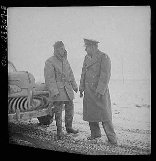 Somewhere in the Persian corridor. A United States Army truck convoy carrying supplies for the aid of Russia. From the left: Captain J. Priggee of Newark, New Jersey, the convoy leader, and Colonel Don Shingler, Commander United States Army truck fleets of Iran and Iraq. Colonel Shingler is wearing a government issue coat. Captain Priggee was a truck dispatcher in private life.