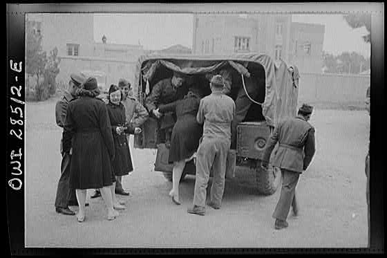 United States Army nurses being helped into the back end of a truck somewhere in Iran