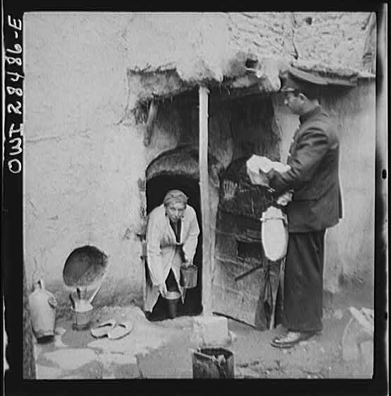Teheran, Iran. Mrs. Louis Dreyfus, wife of the United States Minister to Iran, distributing food to natives
