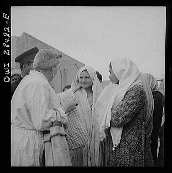 Teheran, Iran. Mrs. Louis Dreyfus, wife of the United States Minister to Iran, talking with native girls