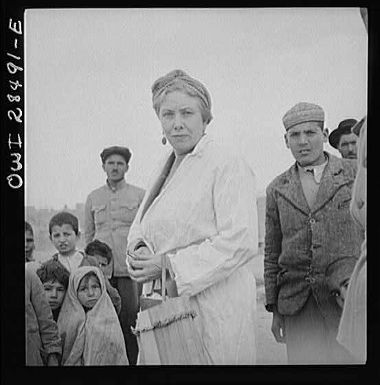 Teheran, Iran. Mrs. Louis Dreyfus, wife of the United States Minister to Iran, visiting a poor section of the city.