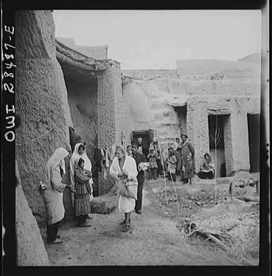 Teheran, Iran. Mrs. Louis Dreyfus, wife of the United States Minister to Iran, visiting a poor section and distributing supplies.