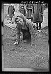 Teheran, Iran. Polish girl landscaping the patch of earth before her tent at an evacuation camp operated by the Red Cross. The Poles take great pride in the cleanliness of their camp