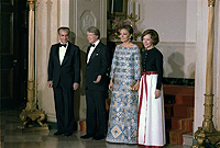 The Shah of Iran, Jimmy Carter, the Shahbanou of Iran and Rosalynn Carter participate in a formal pose during a State Dinner., 11/15/1977 - ARC Identifier: 176872.
