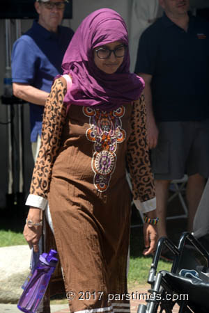 A young muslim woman wearing a purple scarf