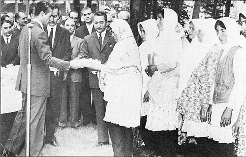 Shah distributing land deeds to village women - Early 1960s