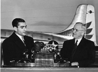 Photograph of the Shah of Iran speaking at Washington National Airport, during ceremonies welcoming him to the United States, as President Truman looks on., 11/16/1949