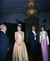 First Lady Jacqueline Kennedy attend a dinner in honor of Mohammad Reza Pahlavi, the Shahanshah of Iran