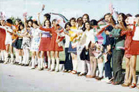 Schoolgirls  wearing mini skirts greet President Nixon and First Lady Patricia Nixon at Tehran Mehrabad Airport, 05/30/1972 - Image courtesy of the Nixon Presidential Library