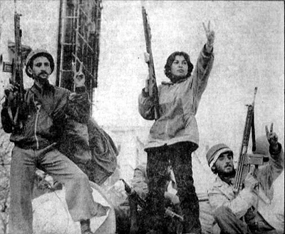 An Iranian woman (most likely a leftist) holding a rifle  celebrates the end of monarchy